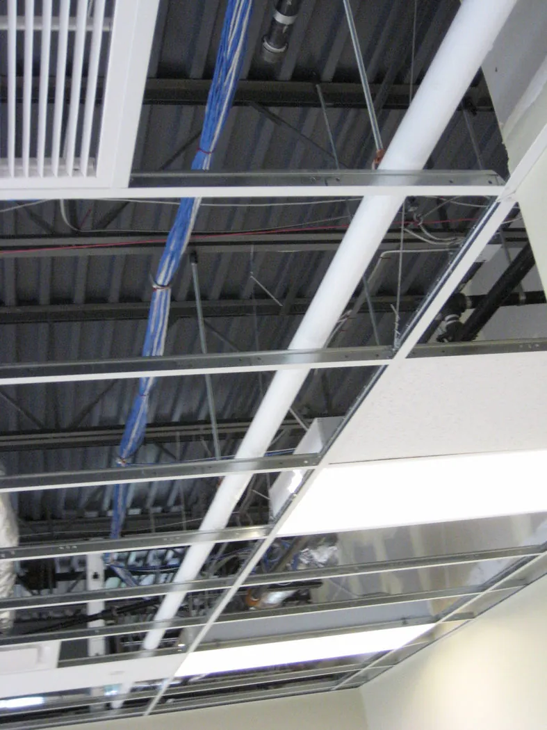 Equipment rack loaded with Panduit cable management panels and rows of blue patch cords feeding into an overhead cable tray.